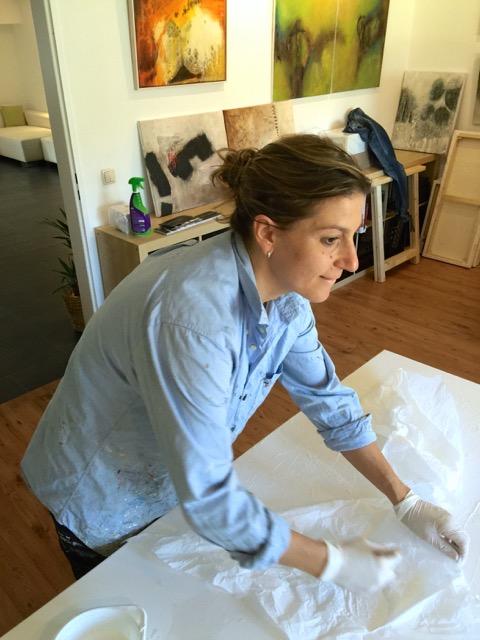 Kirsten Schankweiler working on an abstract painting in her studio